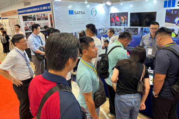 Manufacturers viewing testing equipments and testing standard visitor selecting fashion accessories.