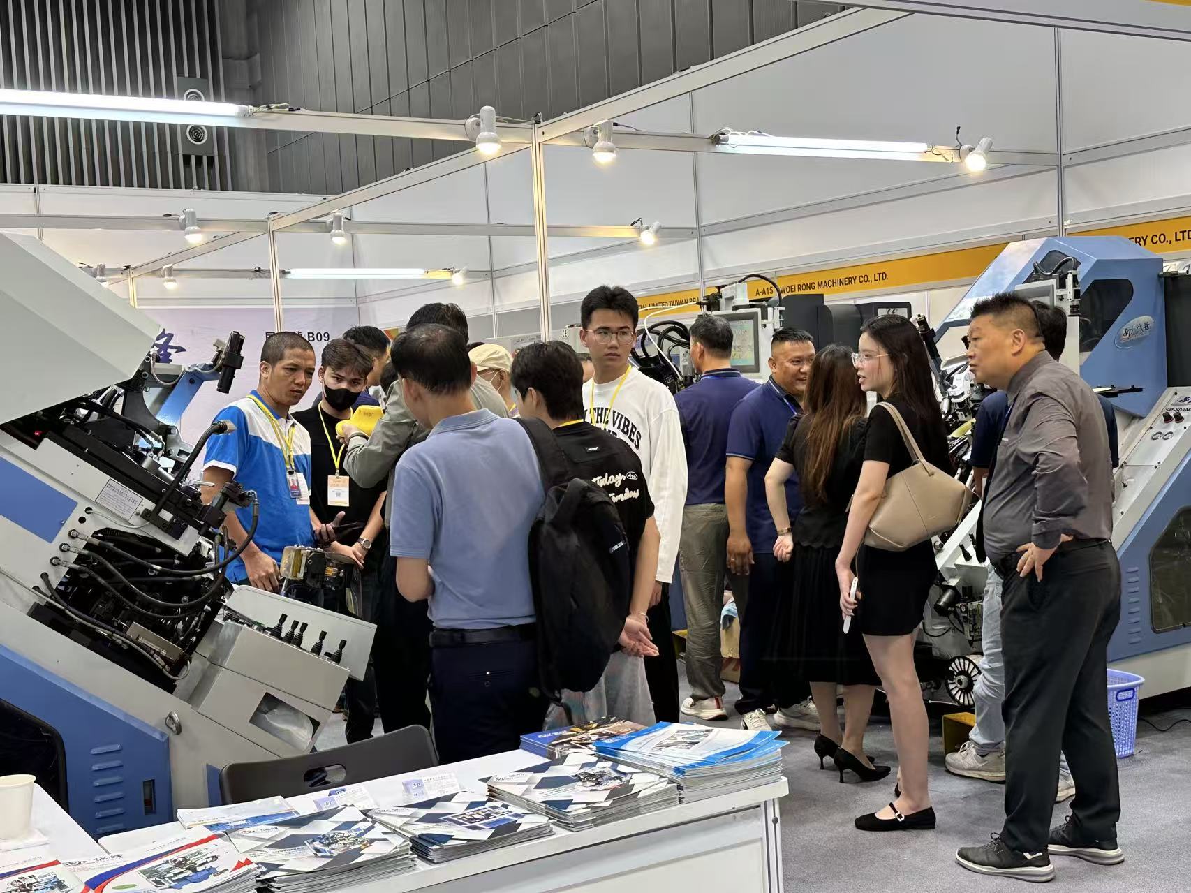 Buyers selecting cutting machine at Shoes and Leather Vietnam by Top Repute Co. Ltd.